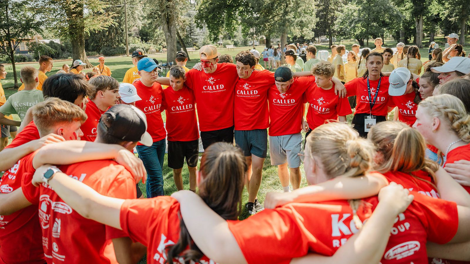 Students in a prayer huddle during field day games at New Saint Andrews College Called Conference in Moscow, Idaho
